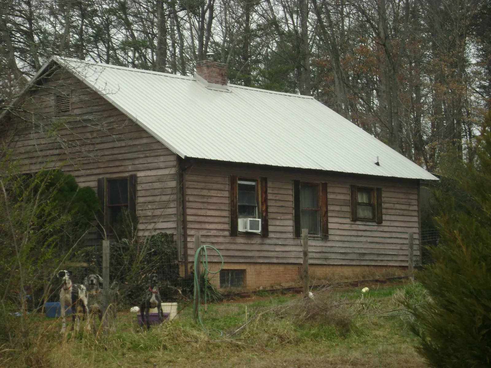 White metal roof on an old wood sided farmhouse, from a Metal Roof Installation job in Leonia